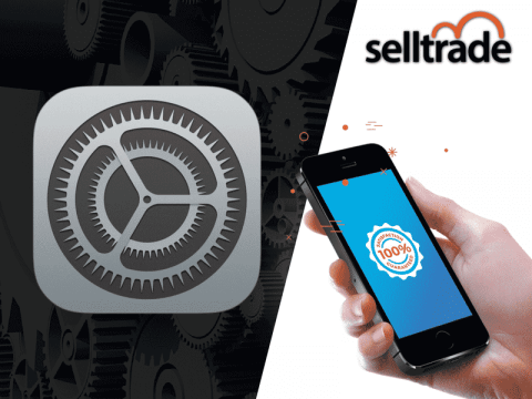 A person is holding an iPhone with the selltrade logo on it.