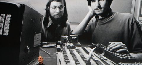 Steve jobs and steve jobs in front of a computer.